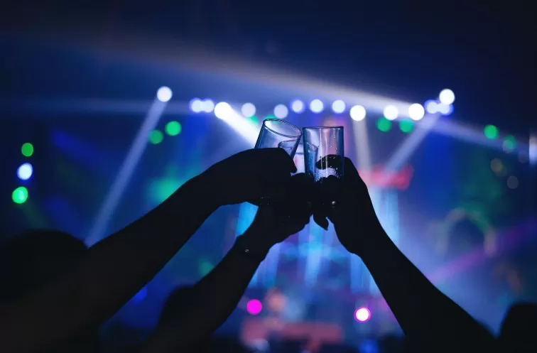 people holding a glass for a toss in the after party